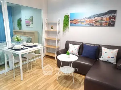 Modern living room with stylish decor and cozy dining area in open layout apartment.