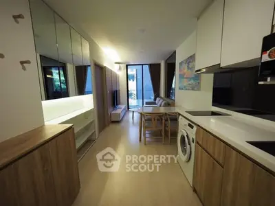 Modern open-plan kitchen and living area with sleek design and natural light.