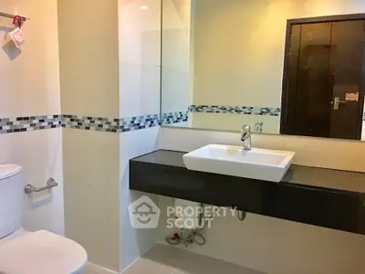 Modern bathroom with sleek sink and stylish tile accents
