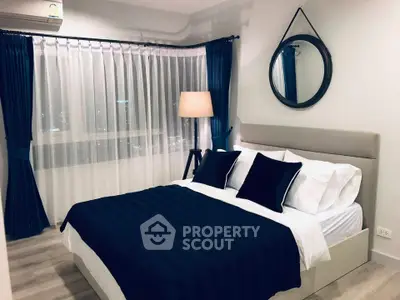 Elegant bedroom with modern decor, featuring a cozy bed, stylish lamp, and large window with city view.
