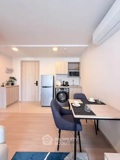 Modern open-plan kitchen and dining area with sleek appliances and stylish decor