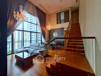 Luxurious duplex living room with high ceilings, chandeliers, and city view.