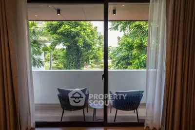 Charming balcony view with cozy seating and lush greenery, perfect for relaxation and enjoying nature.