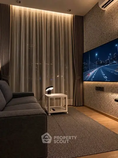 Modern living room with cozy lighting and large TV, perfect for relaxation.
