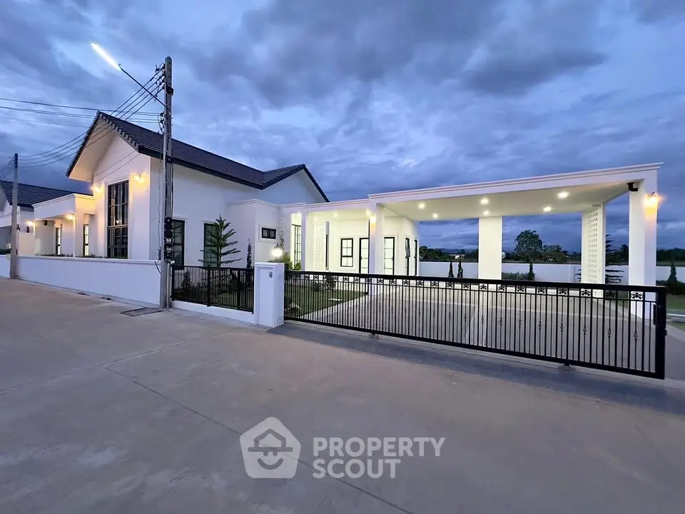 Modern white house with spacious driveway and elegant exterior lighting