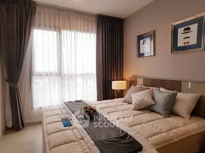 Cozy bedroom with large window and elegant decor in modern apartment.