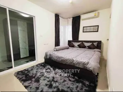 Modern bedroom with plush carpet and stylish decor in a cozy apartment.