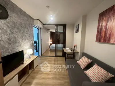 Modern living room with stylish decor and open view to bedroom