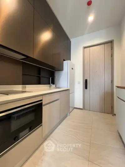 Modern kitchen with sleek cabinetry and built-in appliances in a stylish apartment.