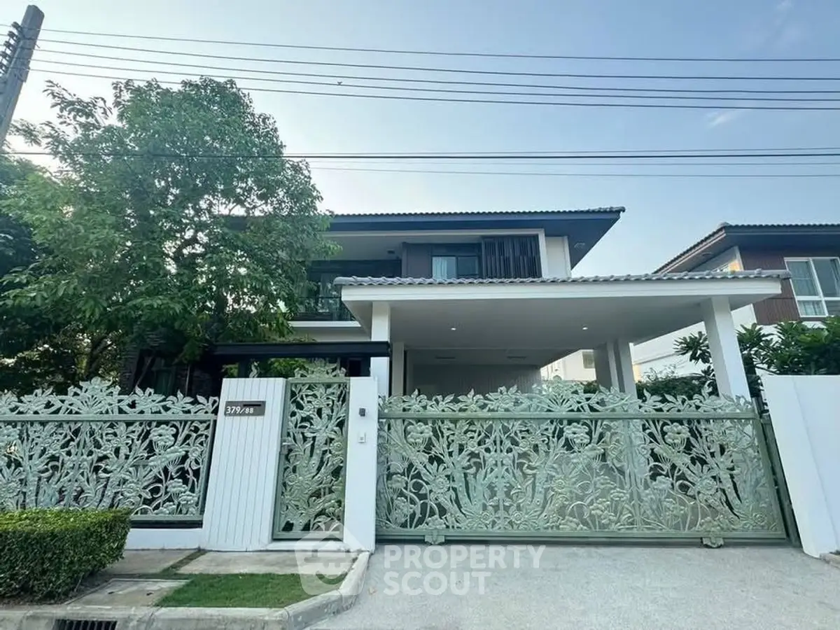 Stunning modern house with intricate gate and lush greenery