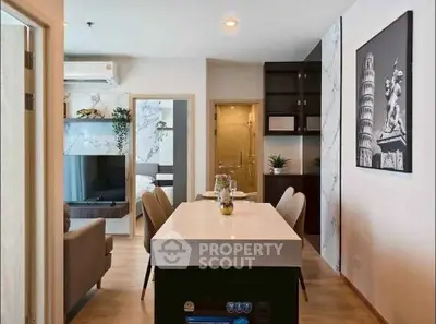 Modern open-plan living and dining area with stylish decor and natural light.