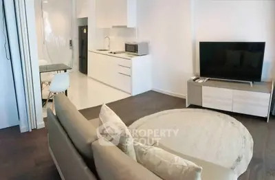 Modern open-plan living room with sleek kitchen and cozy seating area