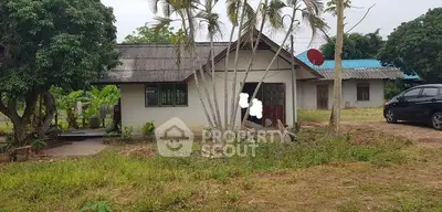 Charming rural house with lush greenery and spacious yard, perfect for tranquil living.