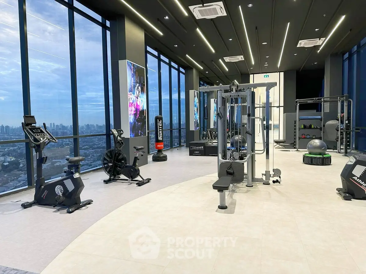 Luxurious high-rise gym with panoramic city views and modern fitness equipment.