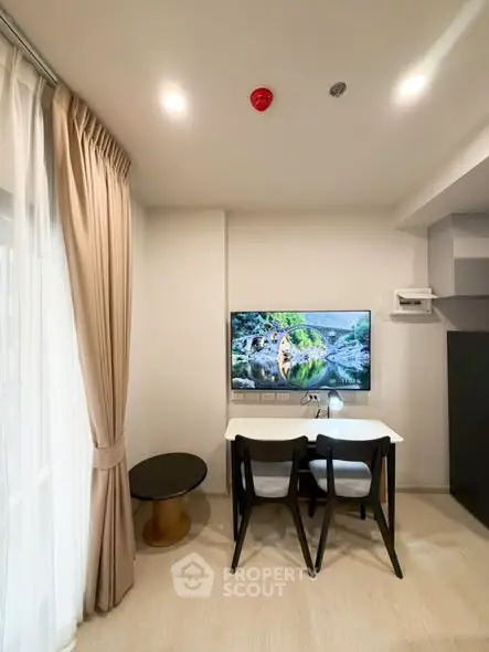 Modern living room with elegant dining area and wall-mounted TV, featuring stylish curtains and sleek furniture.