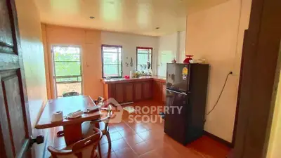 Charming kitchen with natural light, featuring a cozy dining area and modern appliances, perfect for family gatherings.