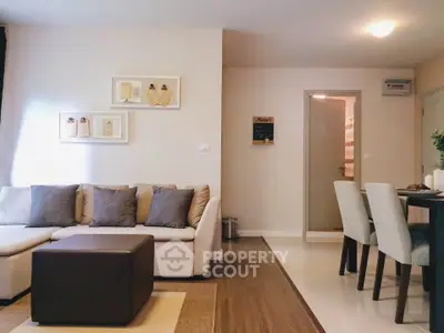 Modern living room with cozy sofa and dining area in stylish apartment.