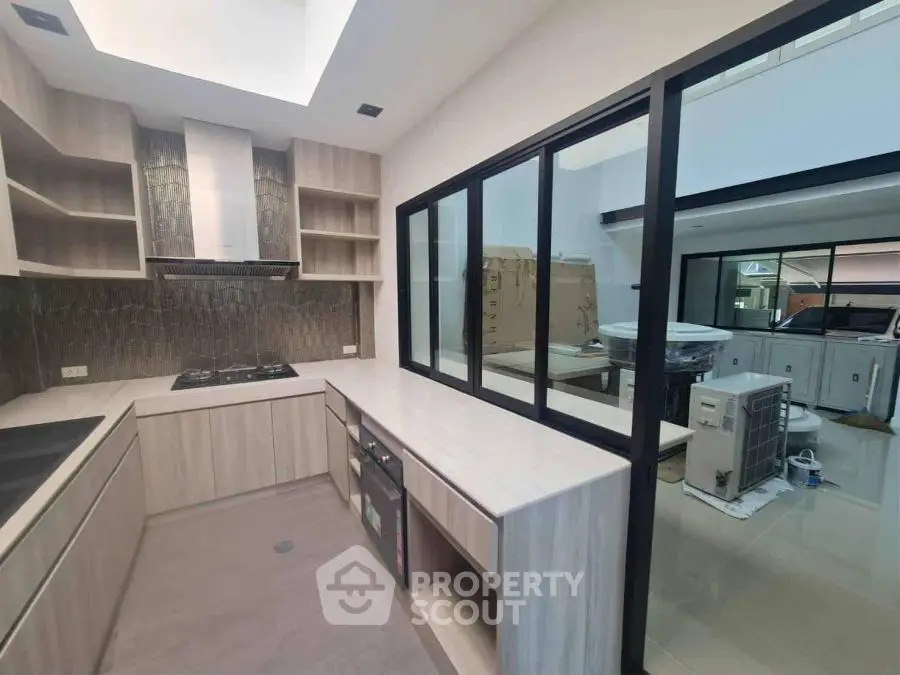 Modern kitchen with sleek cabinetry and gas stove in a contemporary home