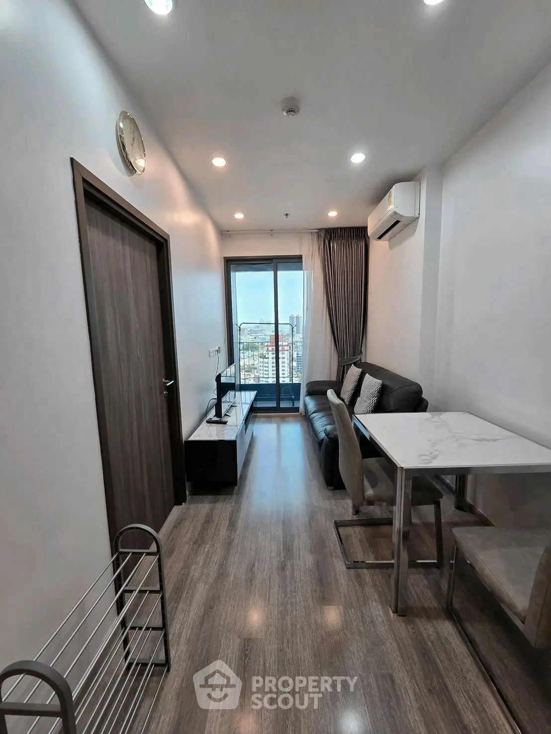 Modern living room with balcony view in high-rise apartment