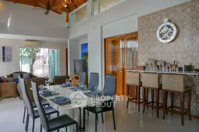 Spacious open-plan living and dining area with modern decor and natural light.