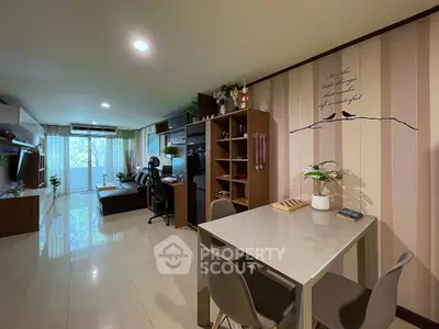 Spacious modern living room with stylish decor and large windows offering natural light.