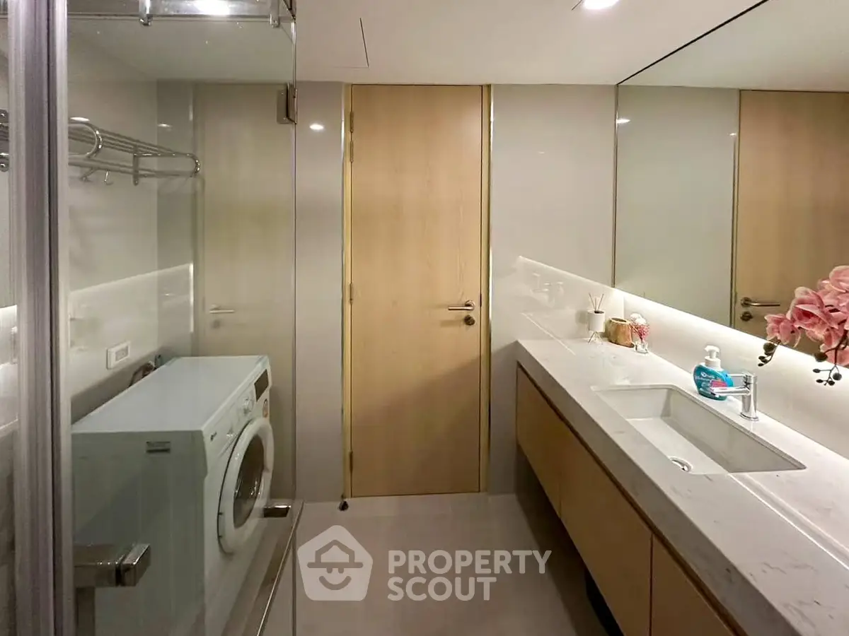 Modern bathroom with sleek design and integrated washing machine