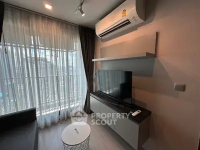 Modern living room with air conditioning and city view, featuring sleek furniture and natural light.