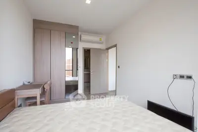 Modern bedroom with built-in wardrobe and air conditioning in a minimalist style.