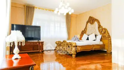 Luxurious bedroom with ornate gold bed and elegant decor