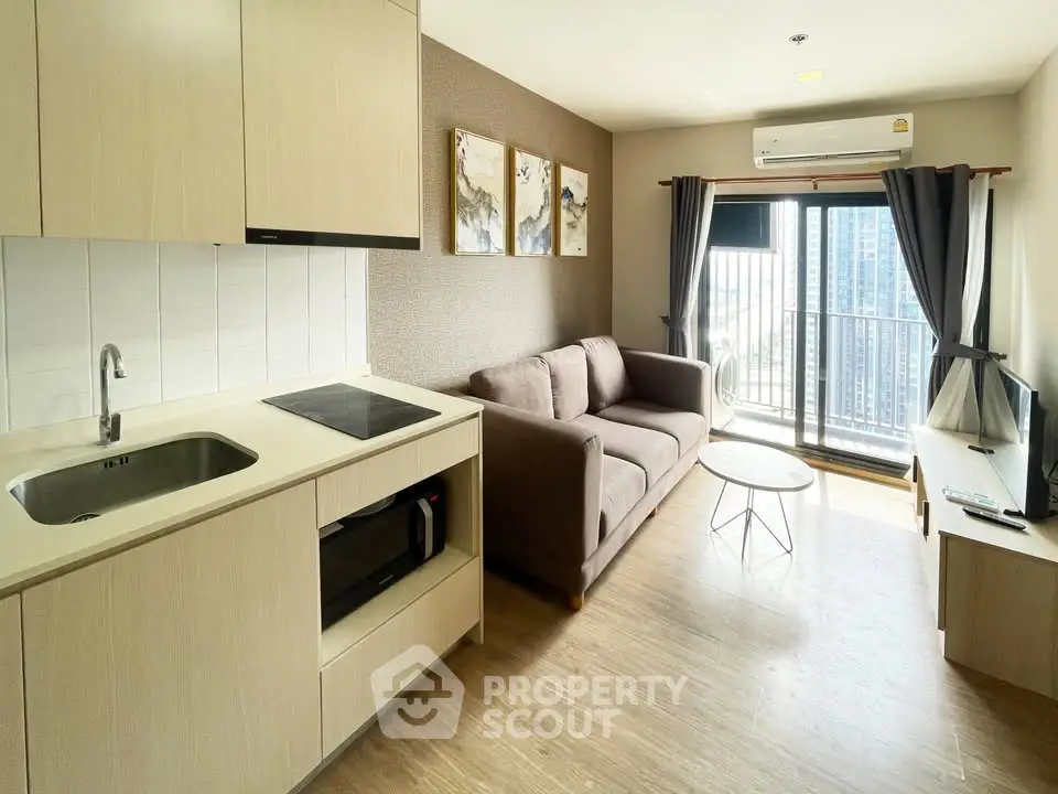 Modern living room with open kitchen and balcony view in high-rise apartment