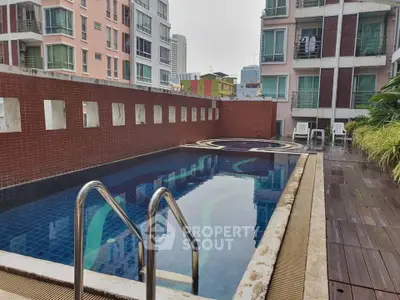 Modern apartment complex with inviting rooftop pool and city views.