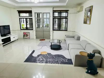 Spacious living room with modern decor and large windows for natural light.