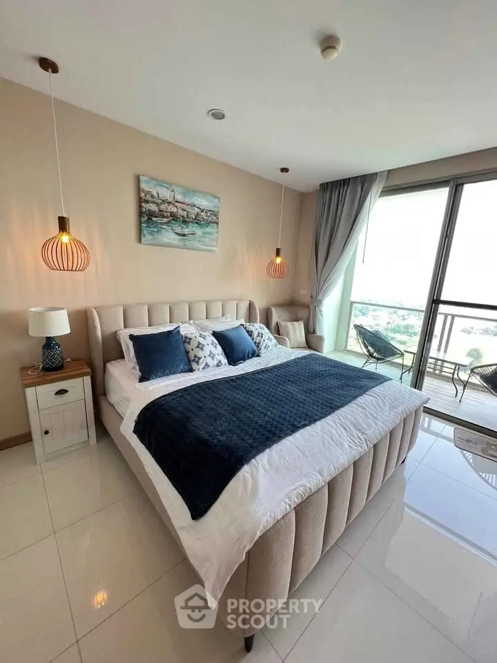 Luxurious bedroom with modern decor and balcony view, perfect for relaxation and comfort.