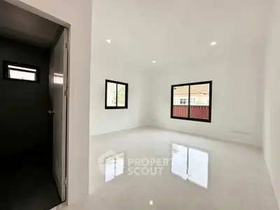 Spacious and bright unfurnished room with large windows and glossy tiled floor, perfect for customization.
