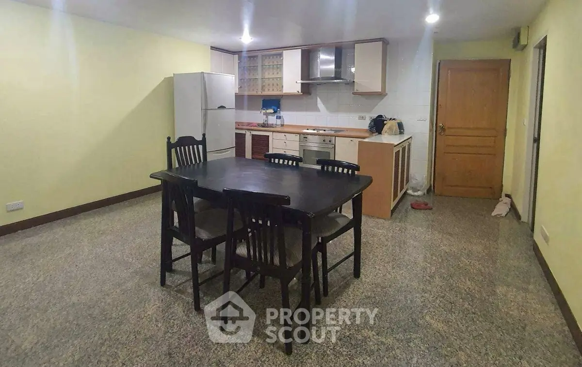 Spacious kitchen with dining area and modern appliances in open layout.