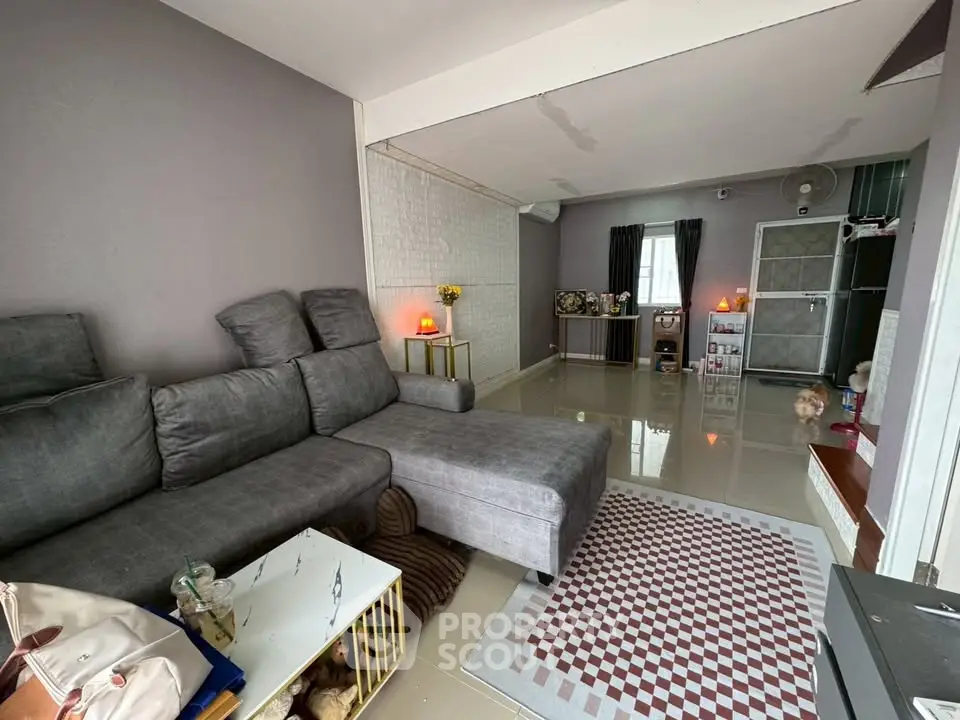 Spacious living room with modern gray sectional sofa and stylish decor