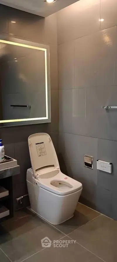Modern bathroom with sleek design and high-tech toilet in luxury real estate property.
