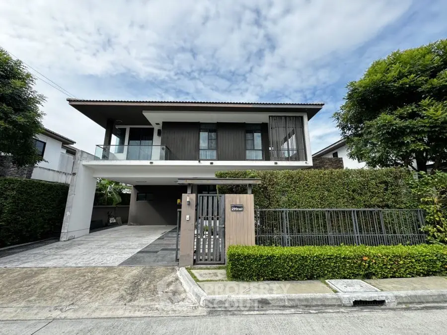 Modern two-story house with lush greenery and spacious driveway