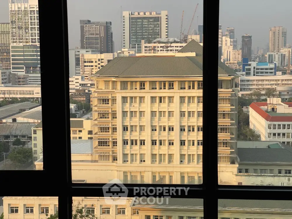 Stunning cityscape view from high-rise building window showcasing urban architecture.