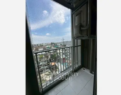 High-rise balcony with cityscape view and safety netting