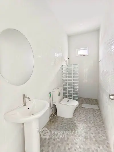 Modern minimalist bathroom with white tiles and sleek fixtures