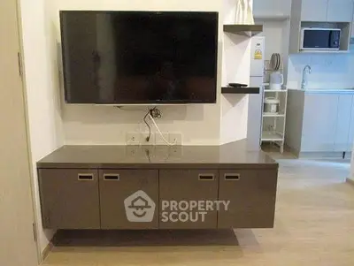 Modern living room with wall-mounted TV and sleek cabinetry