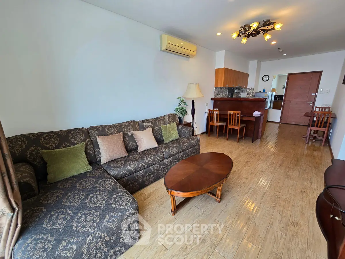 Spacious living room with elegant decor and open kitchen layout in modern apartment.