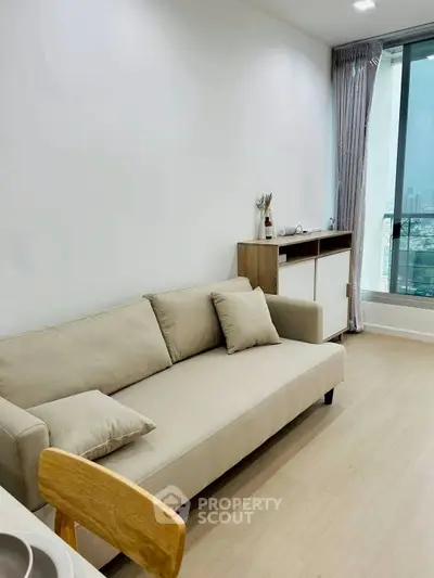 Modern living room with beige sofa and city view window