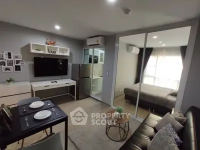 Modern open-plan living room with cozy bedroom and sleek kitchen in stylish apartment.