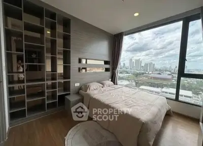 Modern bedroom with large window offering stunning city view