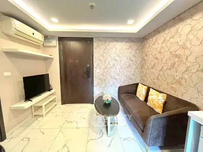 Modern living room with stylish sofa, TV, and elegant decor in a cozy apartment.