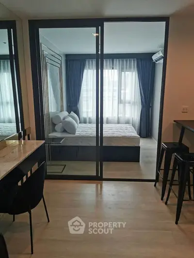 Modern studio apartment with glass partition and elegant decor