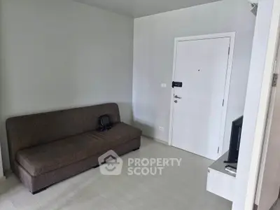 Modern minimalist living room with sleek sofa and TV setup