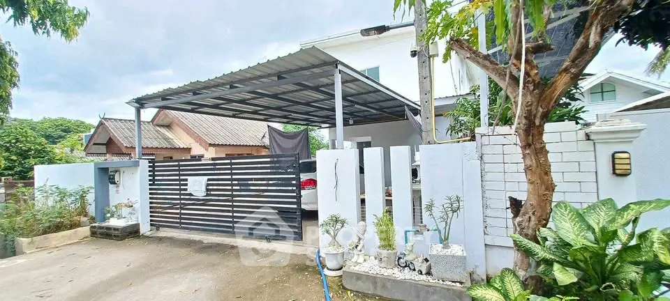 Charming suburban home with covered carport and lush greenery, perfect for family living.